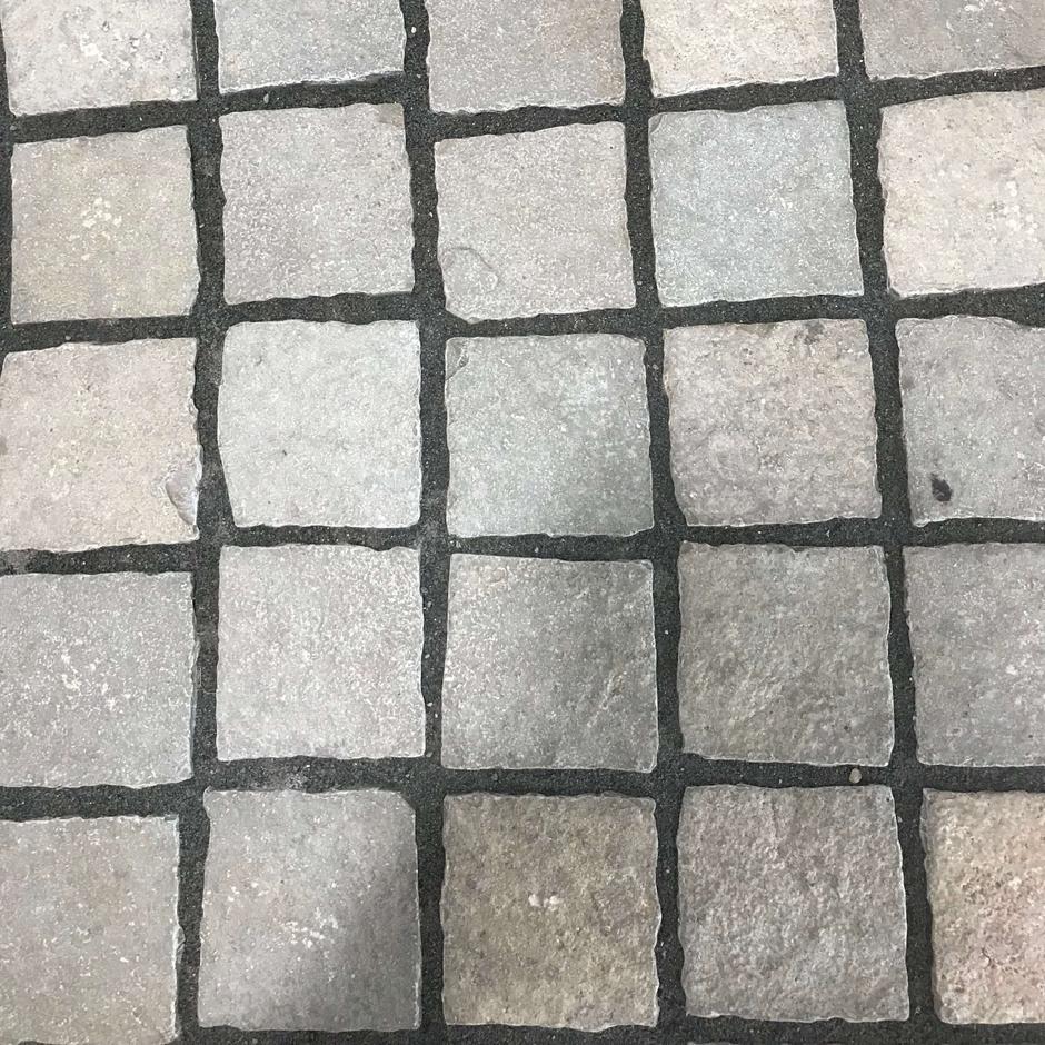 Close up of kota yellow limestone cobble setts paving