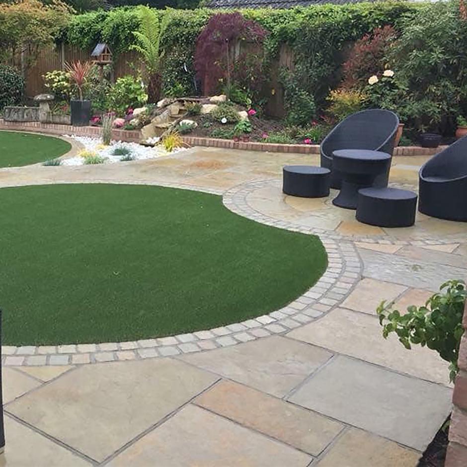 garden with artificial grass and thai yellow limestone paving laid