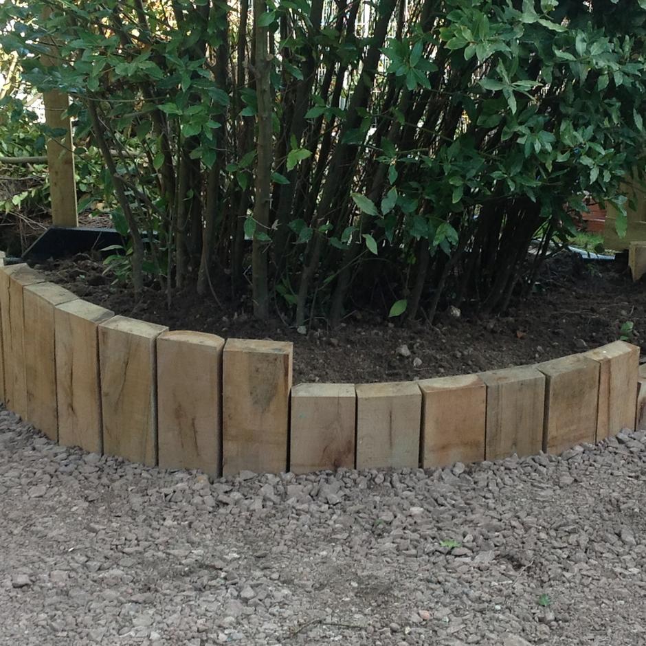 garden sleepers cut down surrounded by chippings