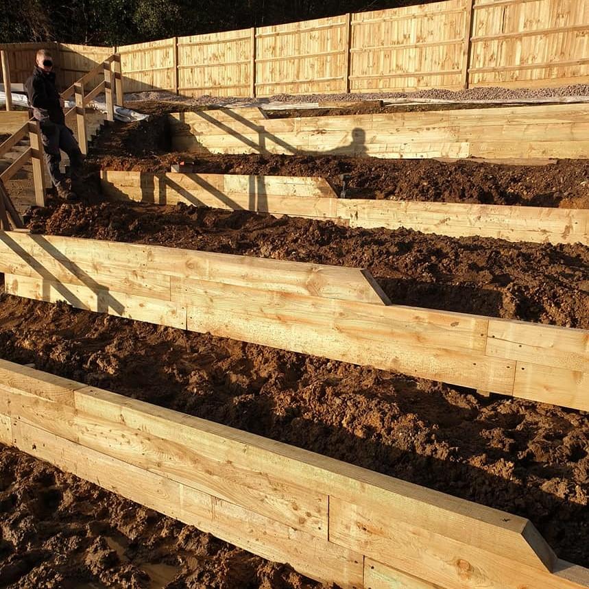 oak sleepers in garden with soil beds
