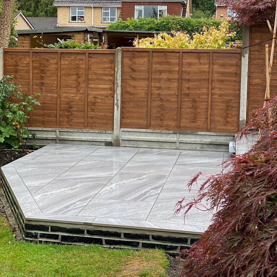Quartzite Grey Porcelain Paving slabs in the back garden with fencing