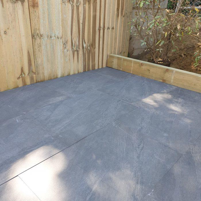 Sienna™ Anthracite Black Porcelain Paving in garden with sleepers