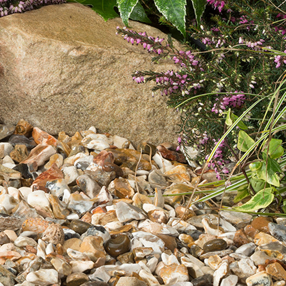 Moonstone Gravel 20mm in garden with rockery