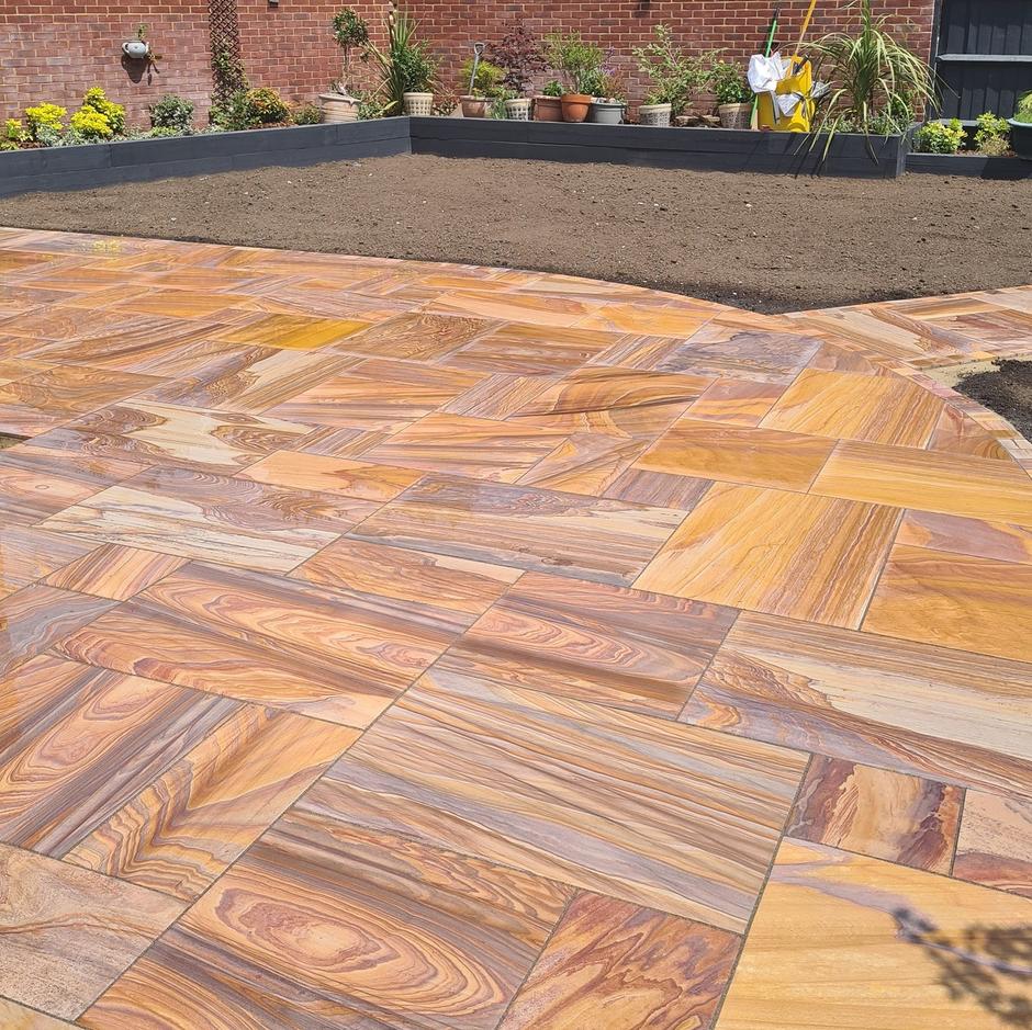 Sawn Rainbow Sandstone Paving with garden plants