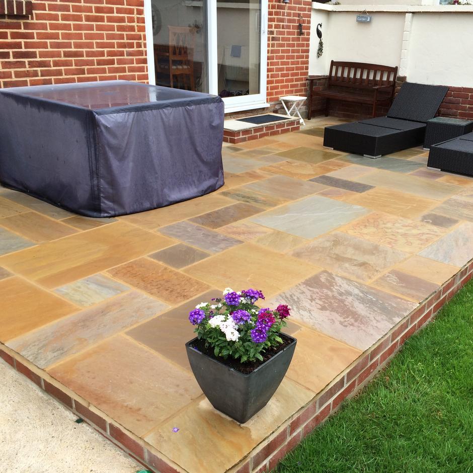 Garden patio with shades of brown sandstone paving