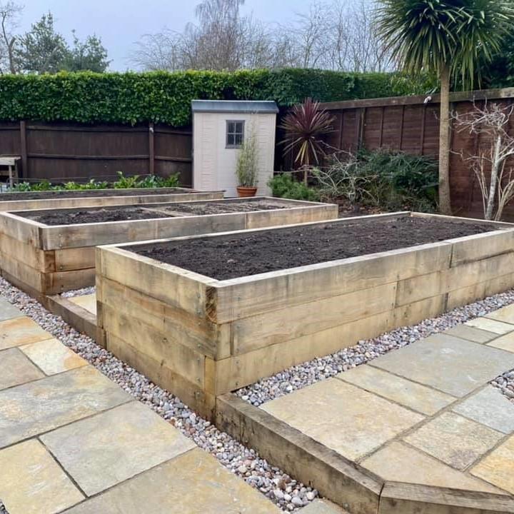 raised oak sleeper beds amongst citron limestone paving