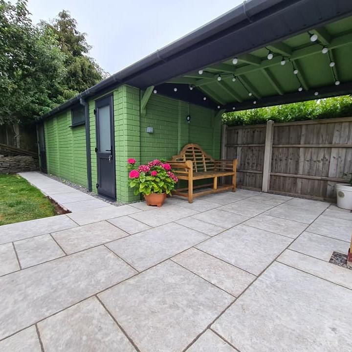 Travertine Silver Weathered Porcelain Paving back garden with shed and garden furniture