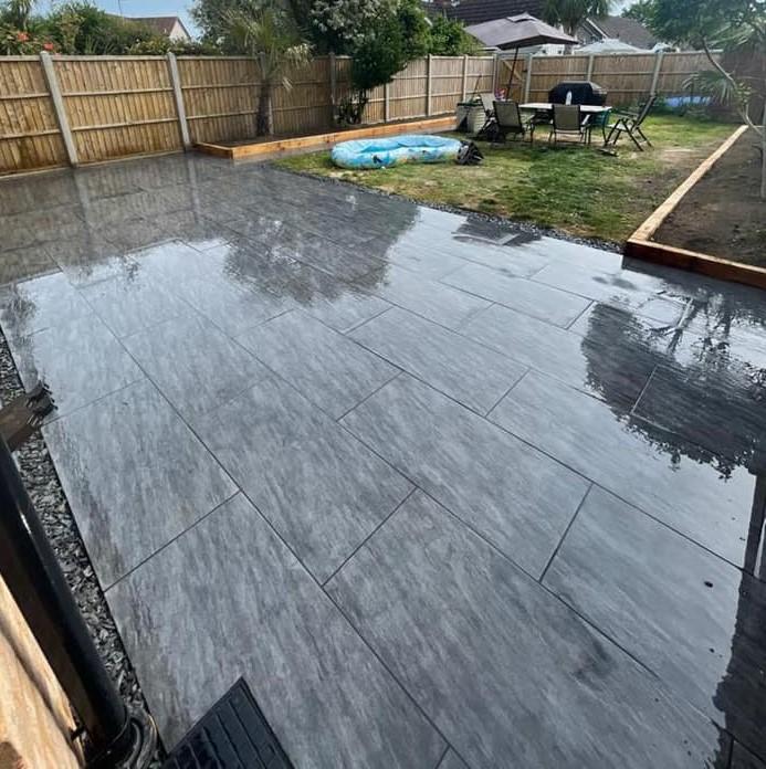 Sienna™ Anthracite Black Porcelain Paving wet in back garden