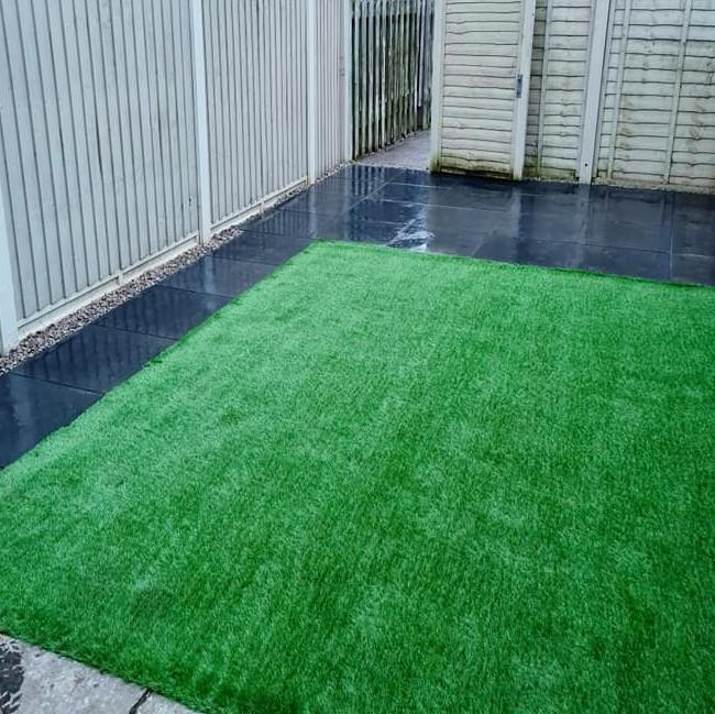 green grass with black paving