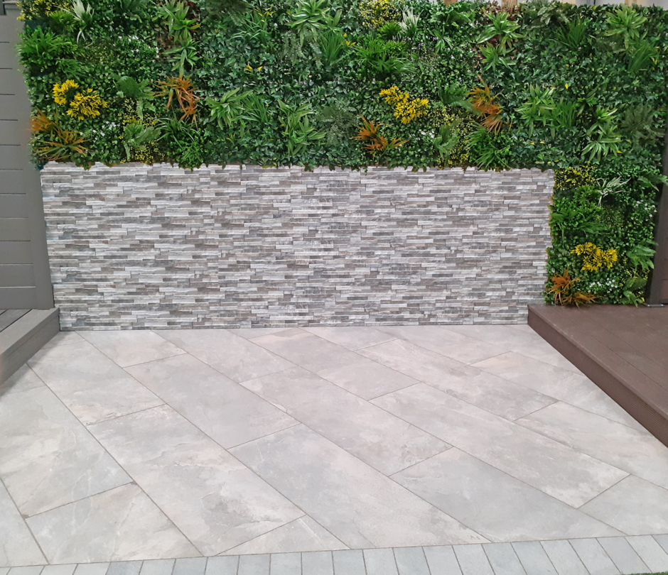 Mixed botanical and lush green wall with paving