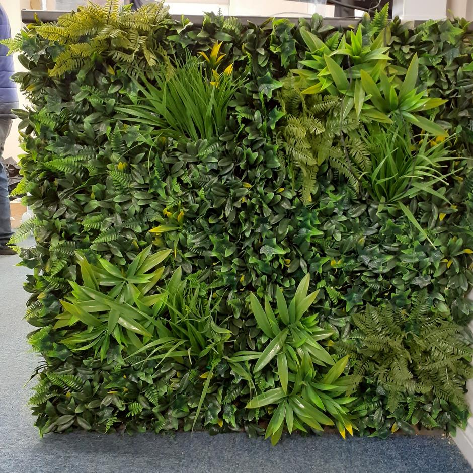 Lush green artificial wall and foliage in office