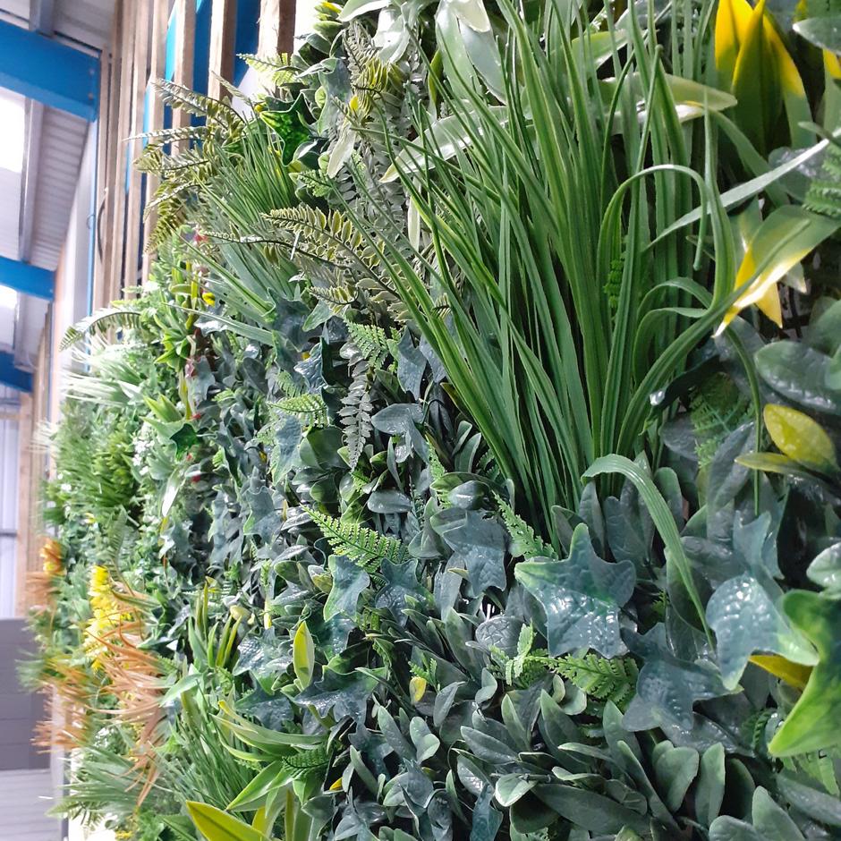 lush green foliage and artificial feature wall