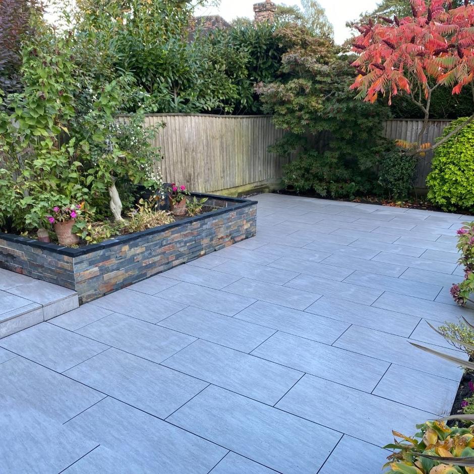 garden with grey paving slabs and cladding