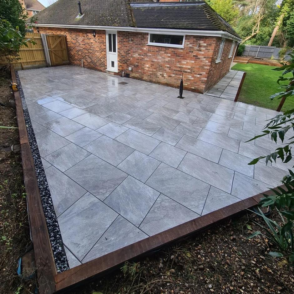 garden project with grey paving slabs and decorative stones