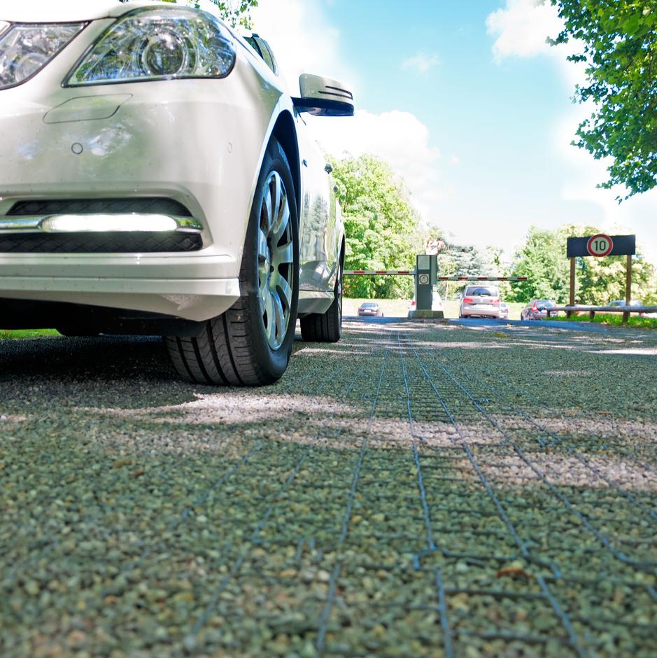 parked car on shingle grid driveway