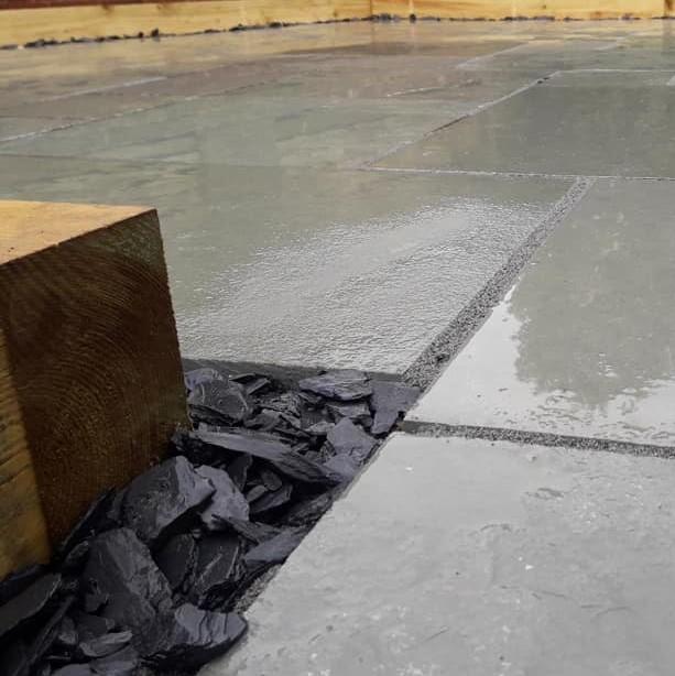 40mm black slate as garden border with aqua blue limestone paving