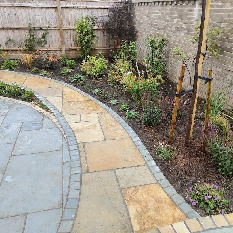 garden borders with pathway containing abbey yellow paving and cobble setts