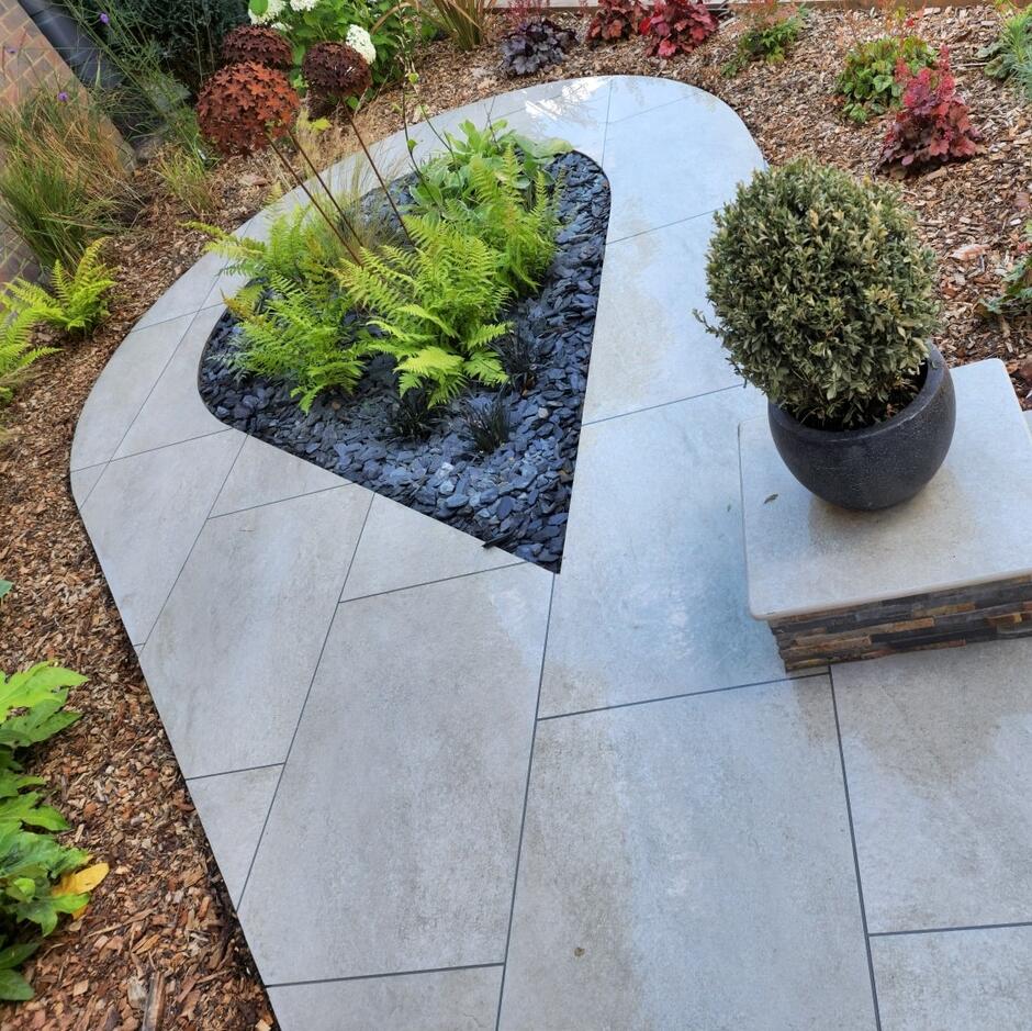 Sienna™ Ocean Mist Porcelain Paving garden with decorative stones