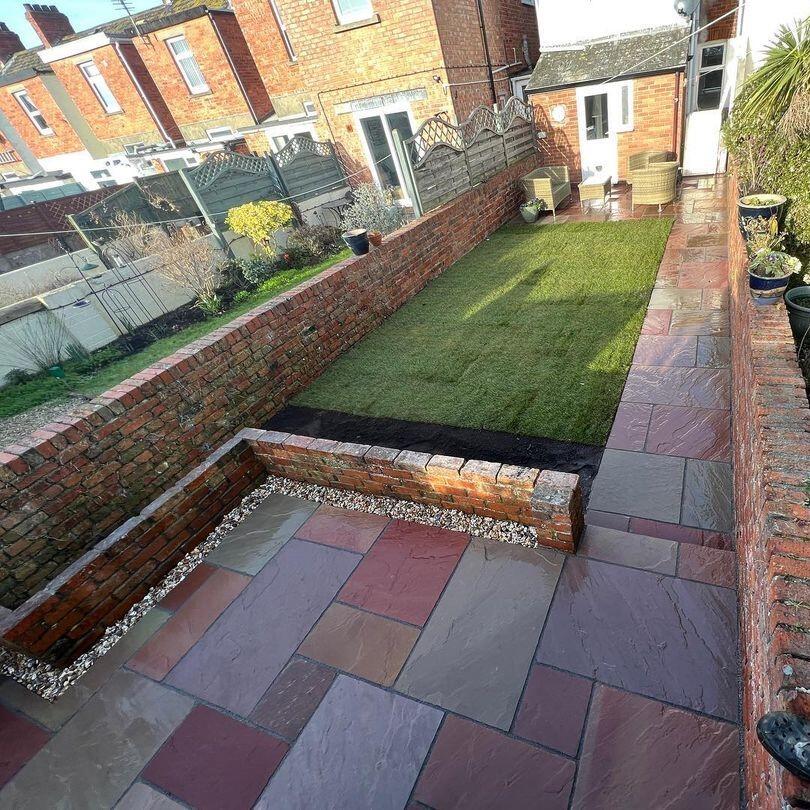 Heather Modak Sandstone Paving with turf area and decorative stones