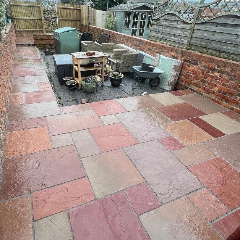 Heather Modak Sandstone Paving slabs entertainment area and fencing