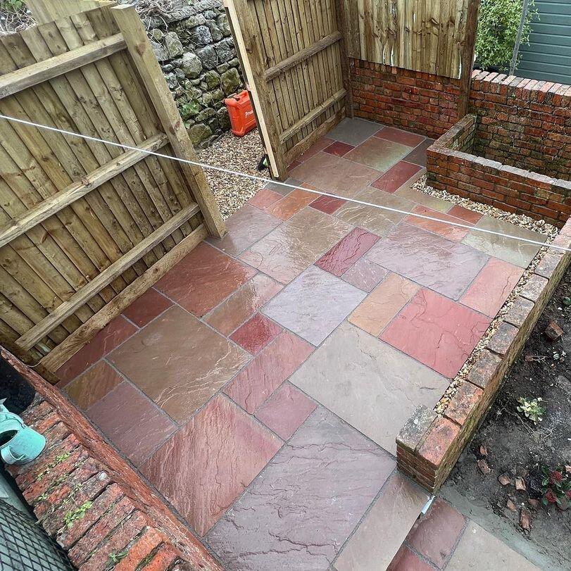 Heather Modak Sandstone Paving with walling and fencing