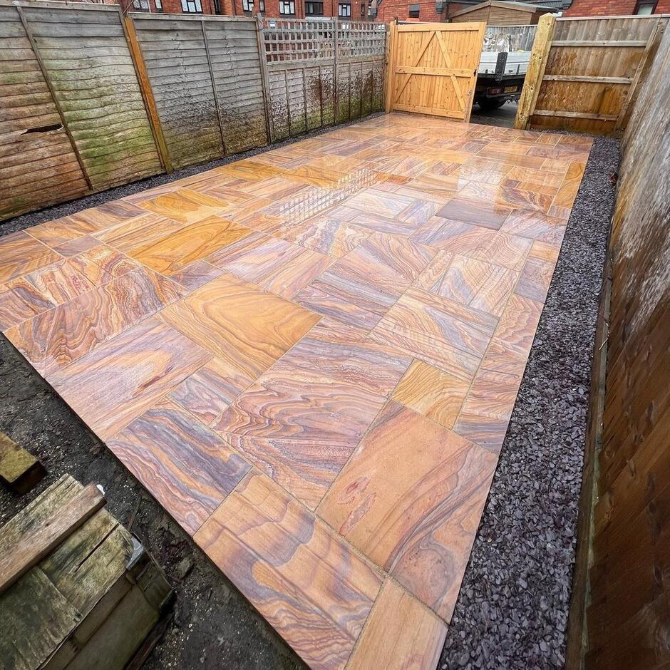 Sawn Rainbow Sandstone Paving garden with fencing