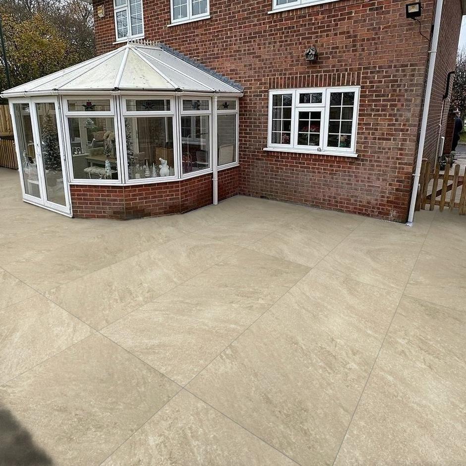 Rasa beige porcelain paving laid within garden patio
