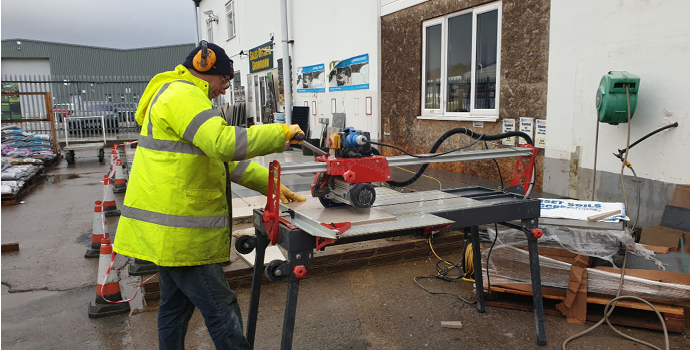 Landscaper cutting outdoor porcelain tiles outside stone zone ferndown