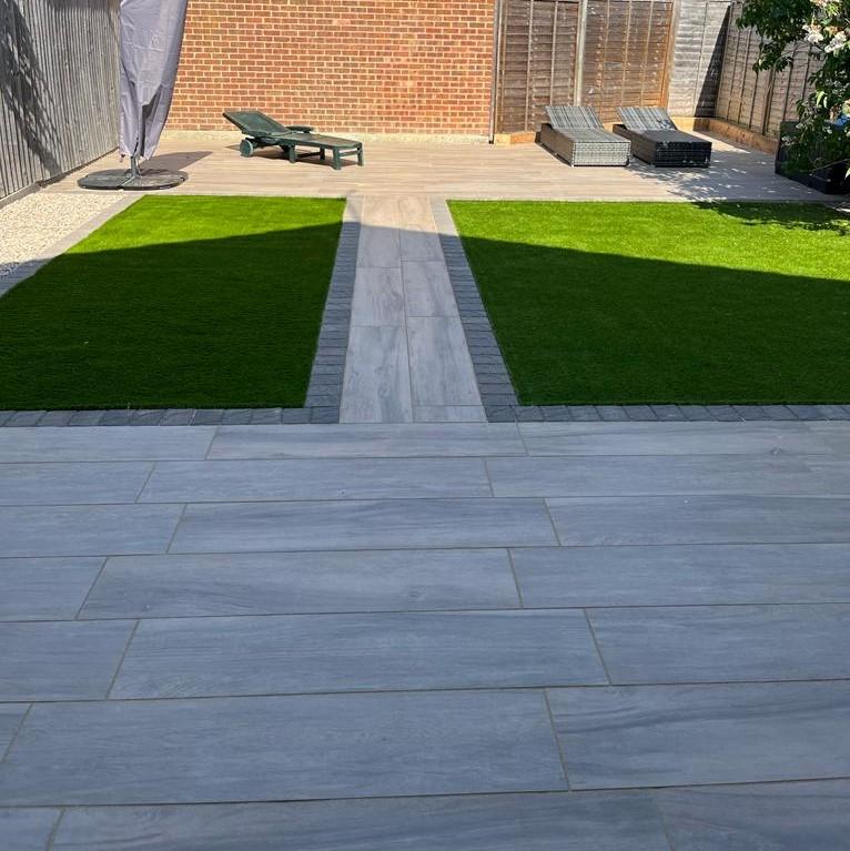 Woodland Pine Wood-Effect Porcelain Paving Planks laid back garden with turf