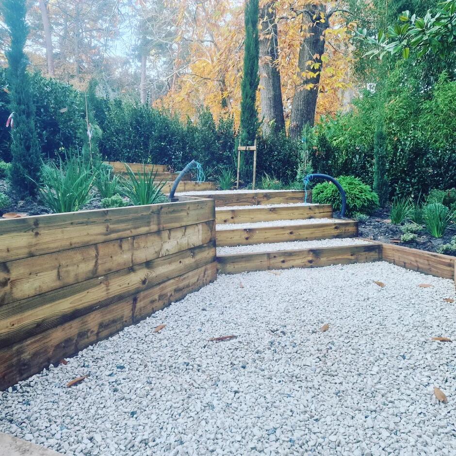 20mm cream purbeck shingle in garden with sleepers