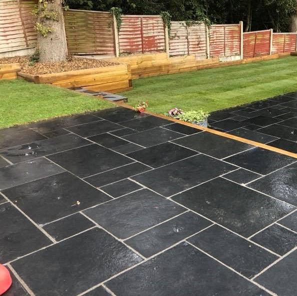 carbon black indian limestone paving slabs with turf grass