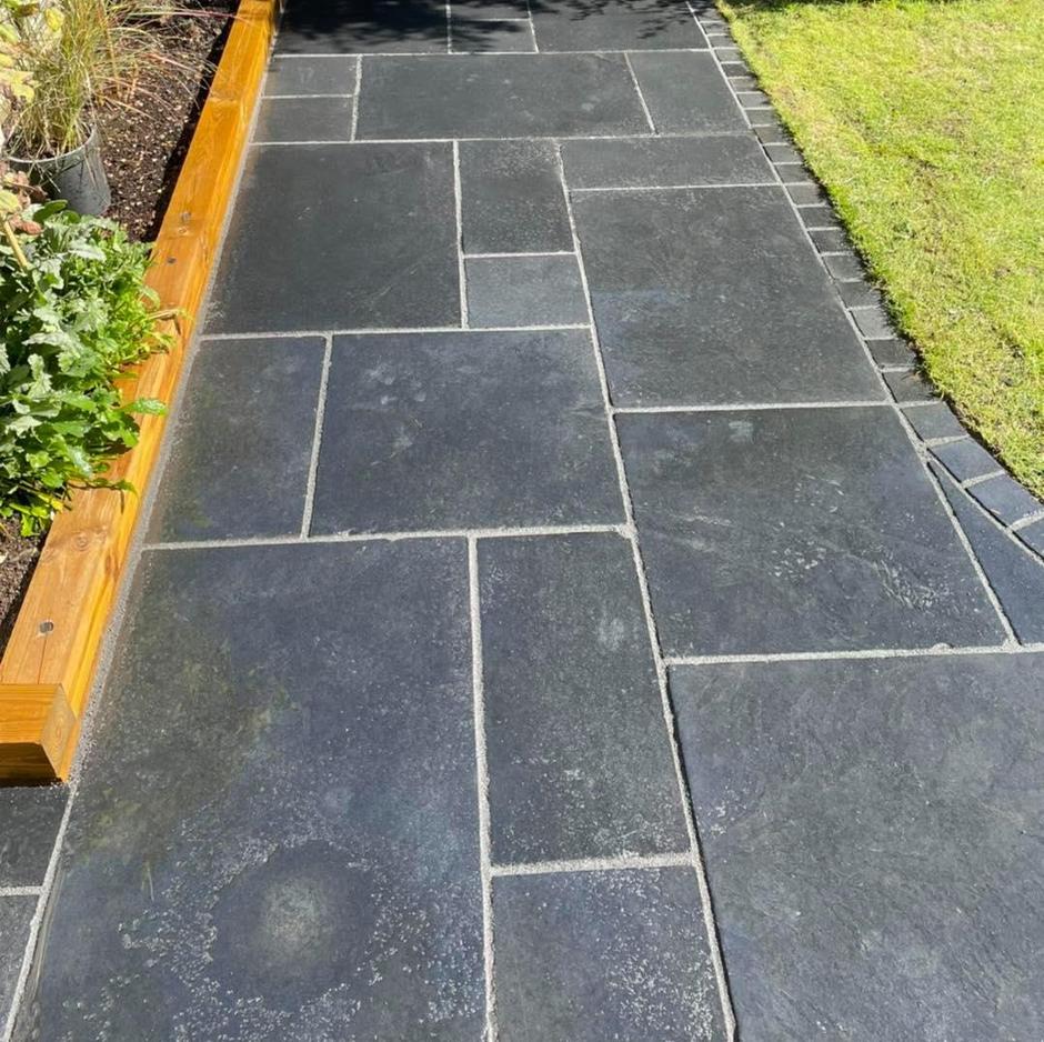 jet black limestone paving slabs with light grout