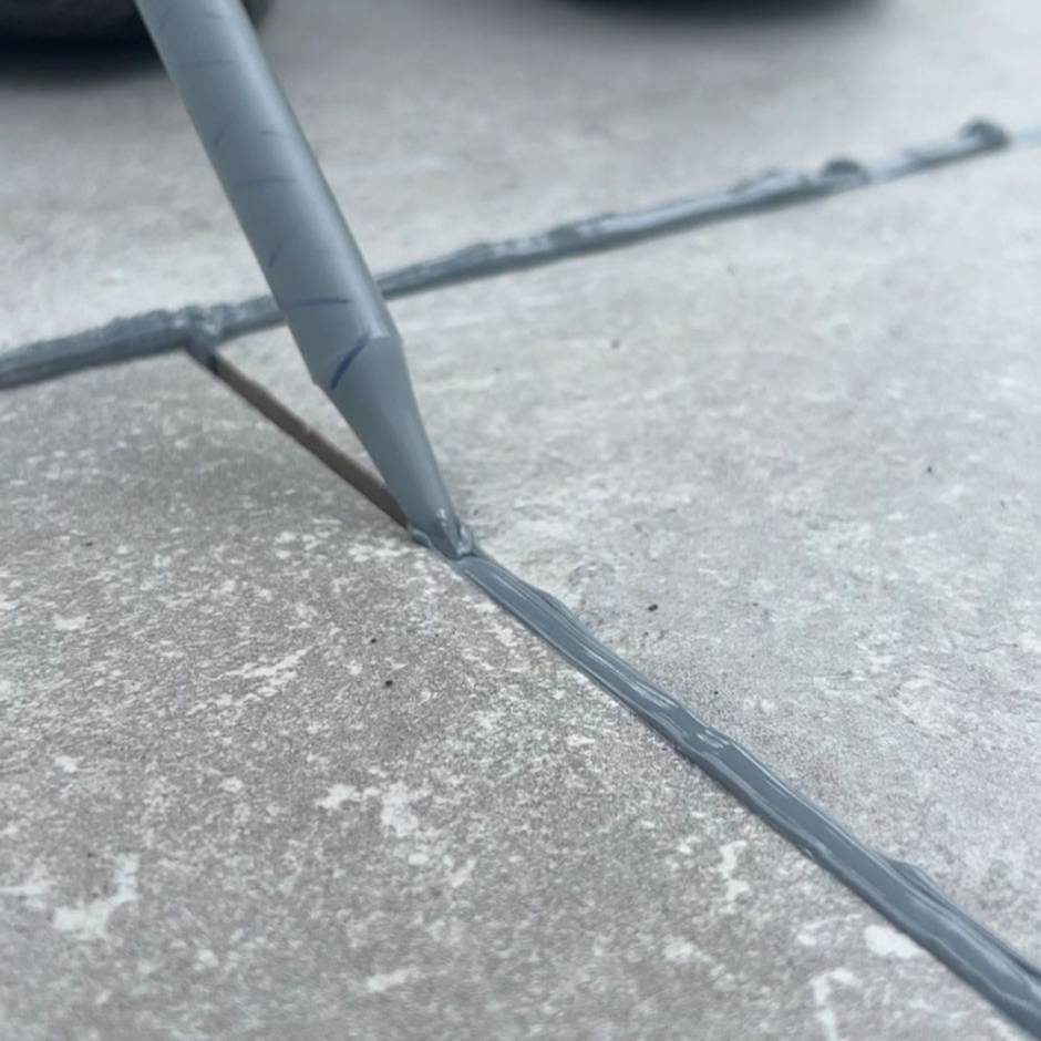 Joint-it epoxy grout being applied to grey porcelain paving