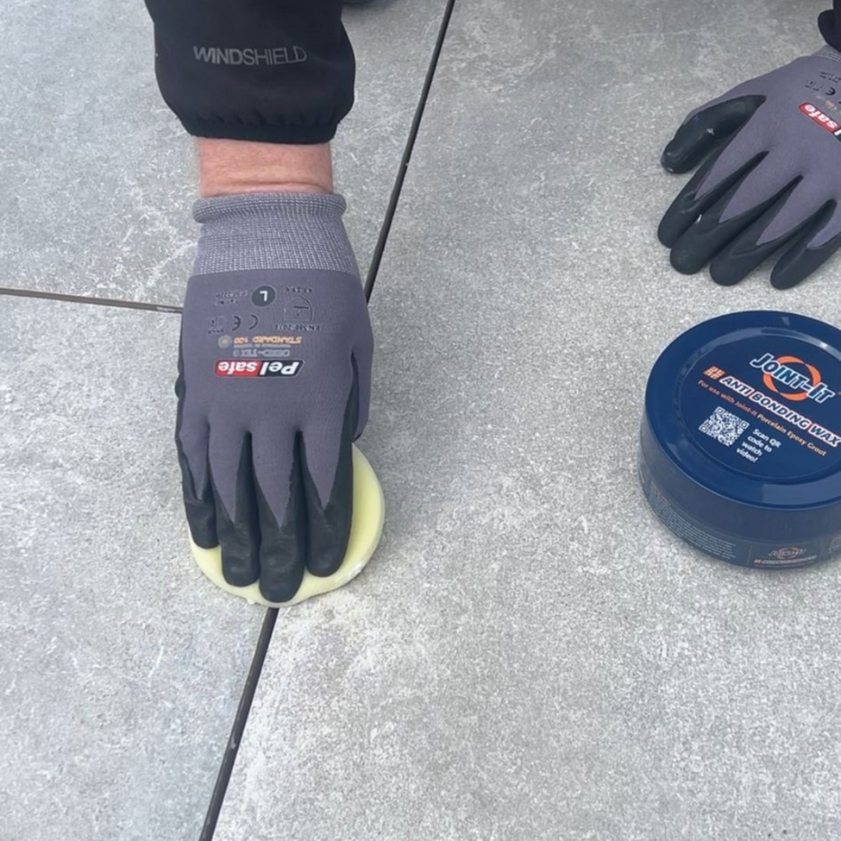 Joint-it anti-bonding wax being applied to grey porcelain paving