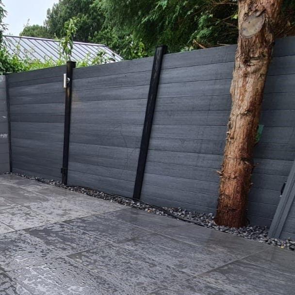 wessex composite grey fencing post and board with decorative stones and turf