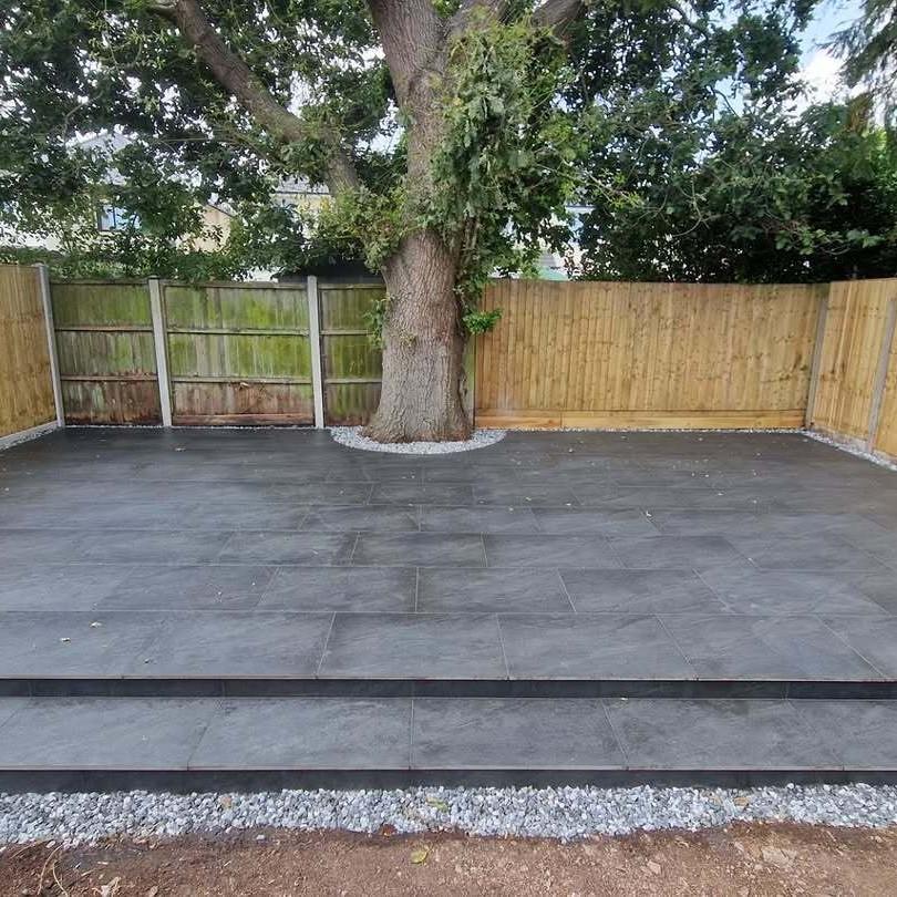 Sienna™ Anthracite Black Porcelain Paving dark grey outdoor slabs with decorative stones