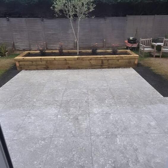 Terrazzano Blanco Porcelain Paving garden patio area with natural wooden sleepers
