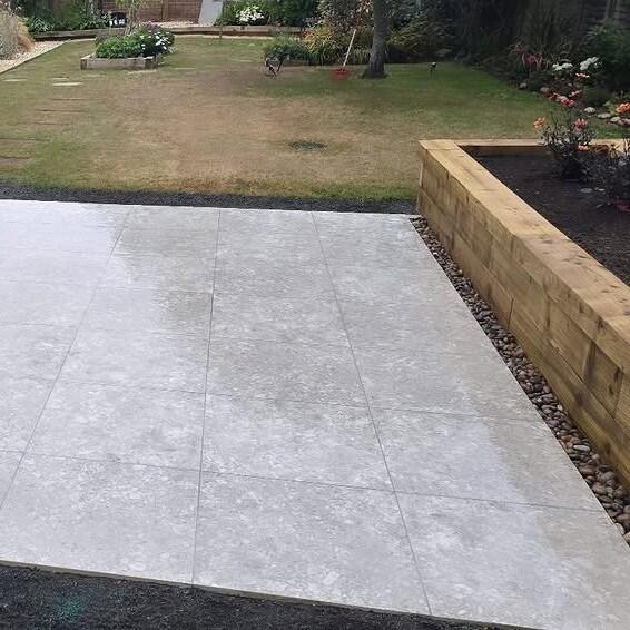 Terrazzano Blanco Porcelain Paving back garden with decorative stones