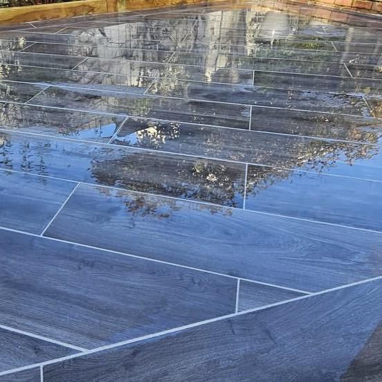 Woodland wood-effect Anthracite Grey Black Porcelain Paving Slab up-close wet finish