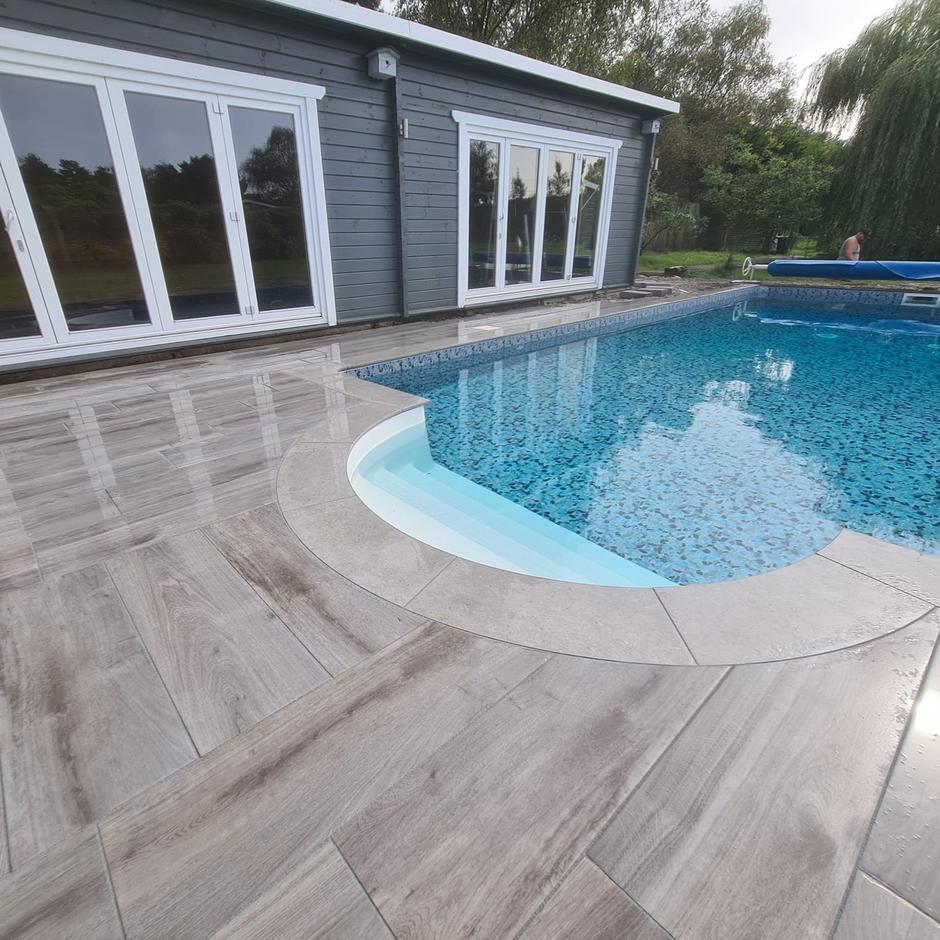 Woodland wood-effect Anthracite Grey Black Porcelain Paving Slab up-close back yard