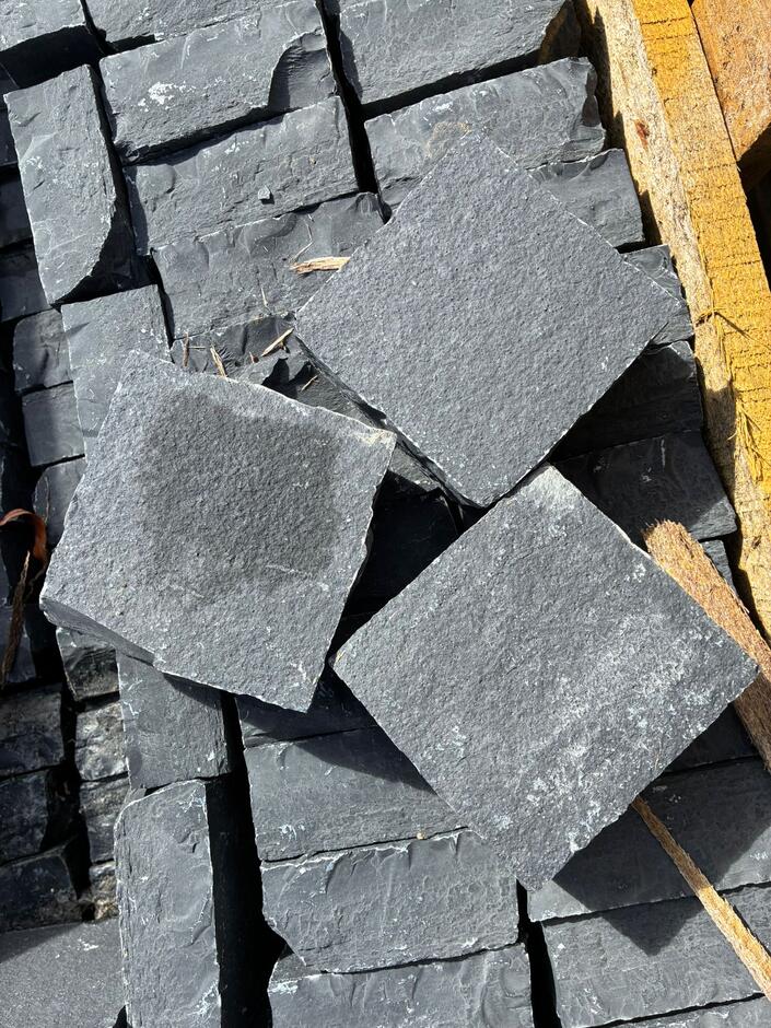 Carbon black limestone cobble setts up close
