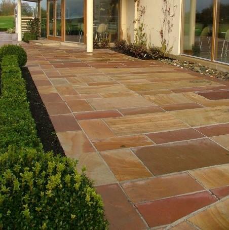 brick red and brown shades of natural stone in back garden