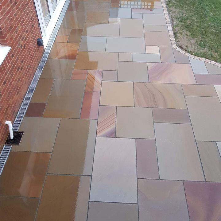 wet sawn sorrel sandstone paving in back garden