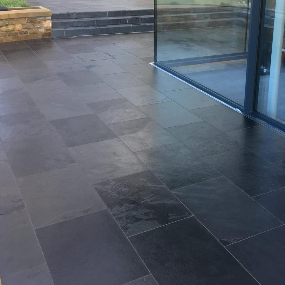 dry black slate paving in garden patio